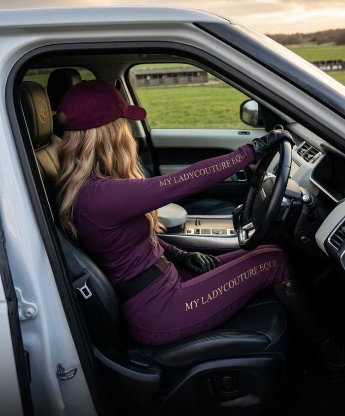 Rider in the plum My Lady set behind the wheel of a car